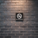 no smoking sign on brick wall