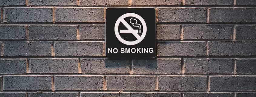 no smoking sign on brick wall