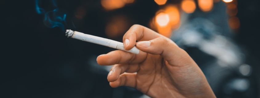 person holding white cigarette stick