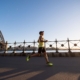 man in yellow tank top running near shore