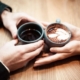 two person holding ceramic mugs with coffee