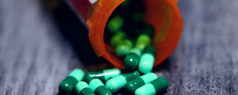 shallow focus photography of prescription bottle with capsules