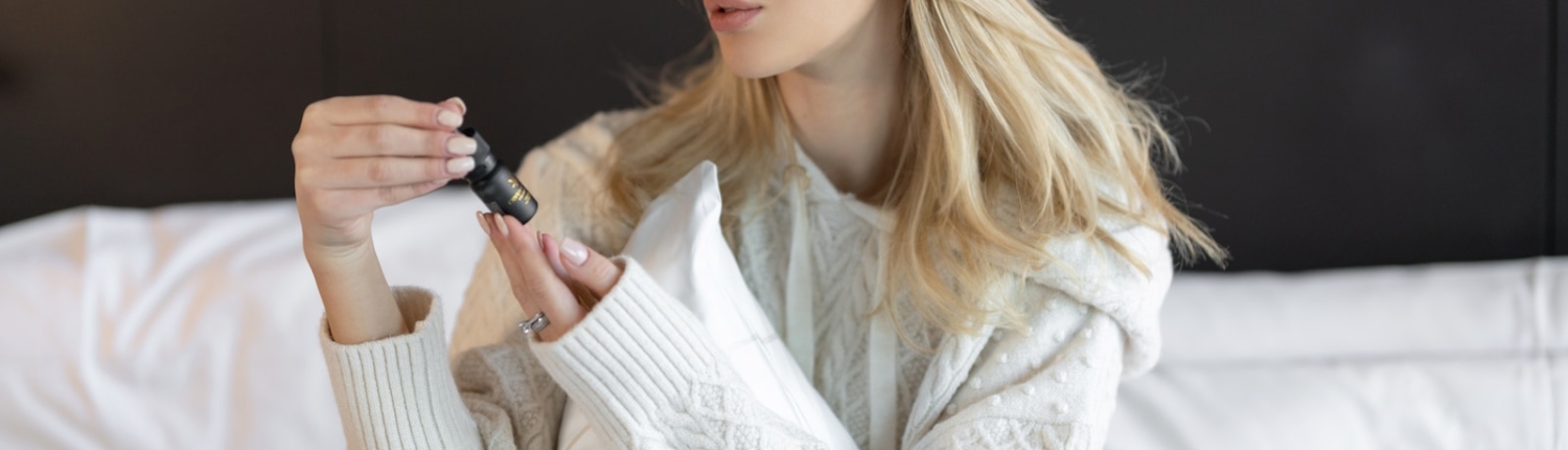 woman in white knit sweater sitting on white sofa