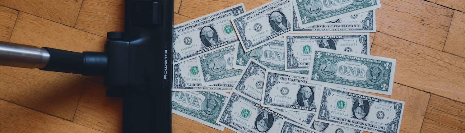 a pile of money sitting on top of a wooden floor