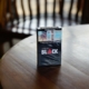 Black cigarette box on top of brown wooden table