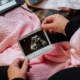 a person is holding a picture of a baby